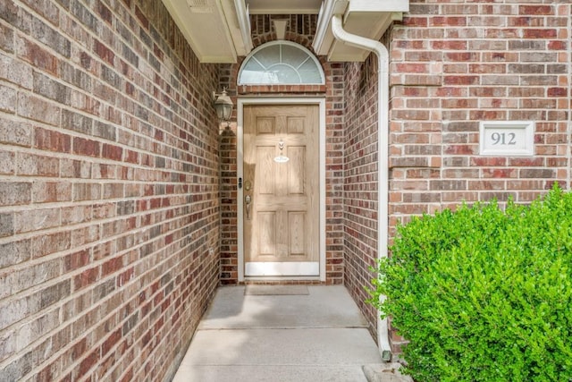 entrance to property with brick siding