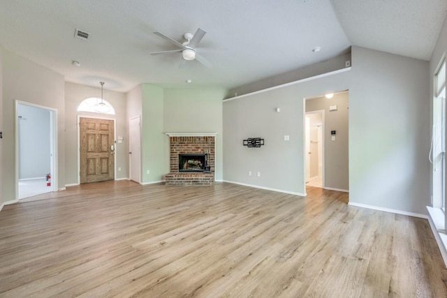 unfurnished living room with light wood-type flooring, a ceiling fan, vaulted ceiling, and a healthy amount of sunlight