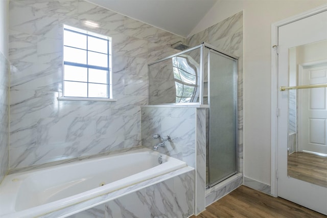 full bath with a garden tub, a stall shower, vaulted ceiling, and wood finished floors