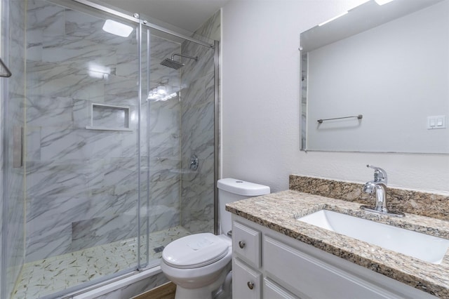 bathroom featuring vanity, toilet, and a marble finish shower