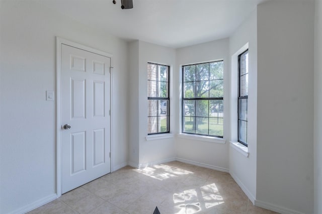 unfurnished bedroom with baseboards and light tile patterned flooring