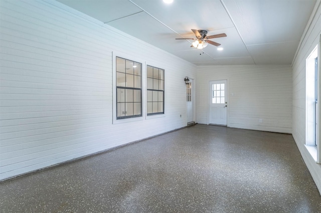 unfurnished room with a ceiling fan and speckled floor