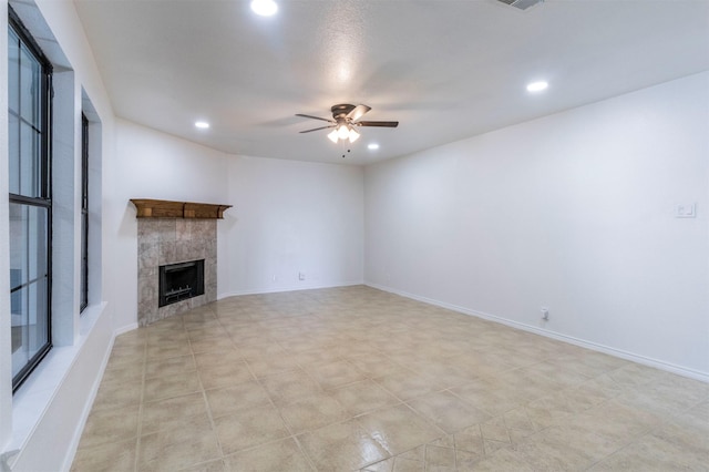 unfurnished living room with recessed lighting, a ceiling fan, visible vents, and a tiled fireplace