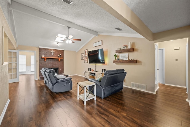 living area with ceiling fan, a fireplace, wood-type flooring, and visible vents