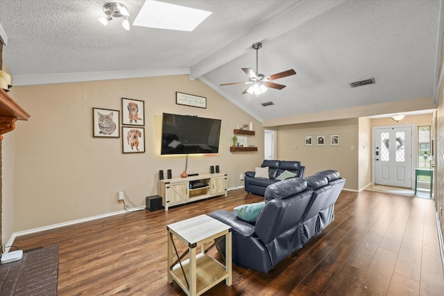 living room featuring dark wood-style flooring, ceiling fan, baseboards, and a textured ceiling