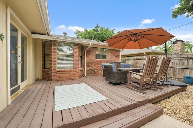 wooden terrace featuring fence and outdoor dining space