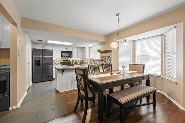 dining room with visible vents, baseboards, and dark wood-style floors
