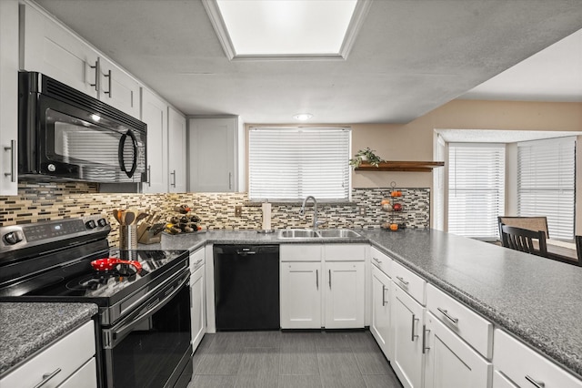kitchen with decorative backsplash, open shelves, a sink, white cabinets, and black appliances