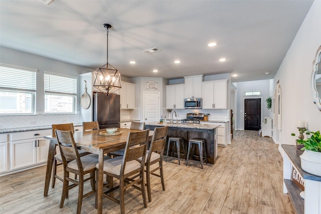 148 Mossy Oak Trl, Fort Worth, TX 76131 - dining area with a chandelier, light wood finished floors, and recessed lighting