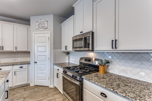 148 Mossy Oak Trl, Fort Worth, TX 76131 - kitchen featuring appliances with stainless steel finishes, white cabinets, and light wood-style flooring