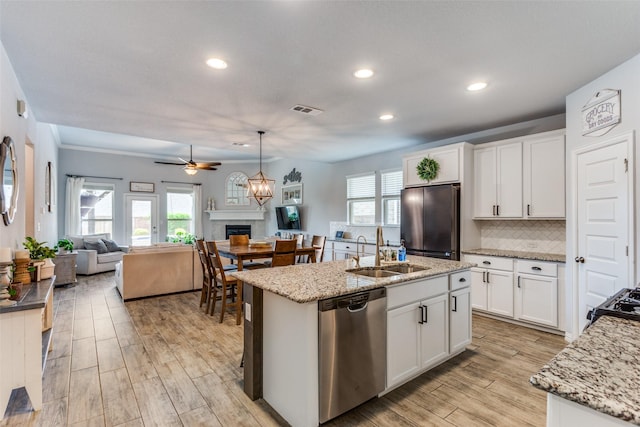 148 Mossy Oak Trl, Fort Worth, TX 76131 - kitchen featuring appliances with stainless steel finishes, light wood-type flooring, recessed lighting, open floor plan, and backsplash