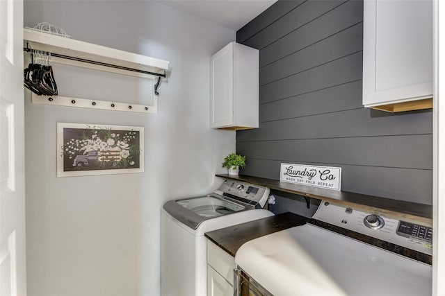 148 Mossy Oak Trl, Fort Worth, TX 76131 - washroom with washer and dryer, cabinet space, and wood walls