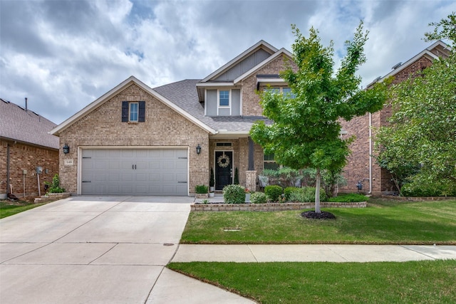 craftsman inspired home featuring driveway, a front yard, brick siding, an attached garage, and a shingled roof