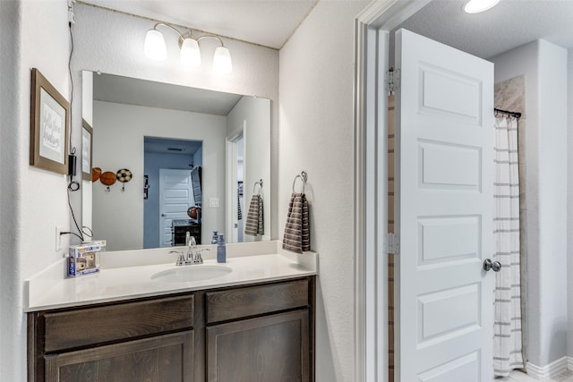 full bathroom with vanity and a shower with shower curtain