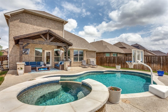 view of pool featuring a patio, a pool with connected hot tub, an outdoor living space, and a fenced backyard
