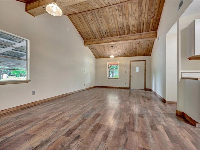 interior space with visible vents, wood finished floors, beamed ceiling, baseboards, and high vaulted ceiling