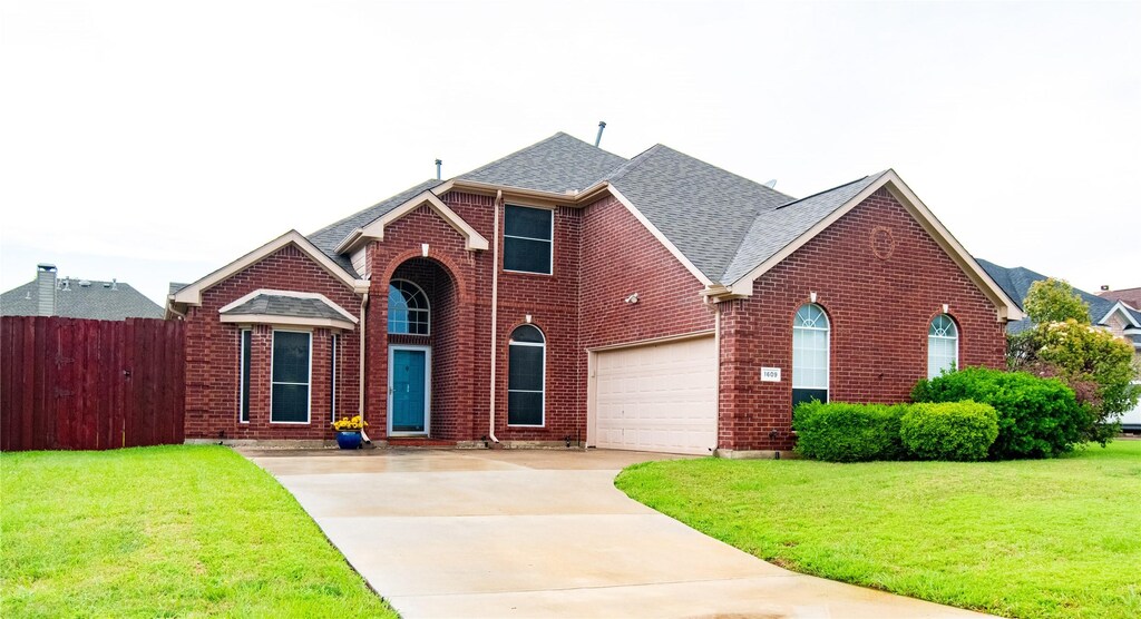 1609 Fairfax Dr, Mansfield, TX 76063 - traditional-style home featuring brick siding, a shingled roof, fence, and driveway