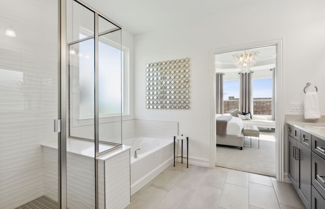 2713 Creekdale Dr, Celina, TX 75009 - ensuite bathroom with an inviting chandelier, a healthy amount of sunlight, a bath, and a stall shower