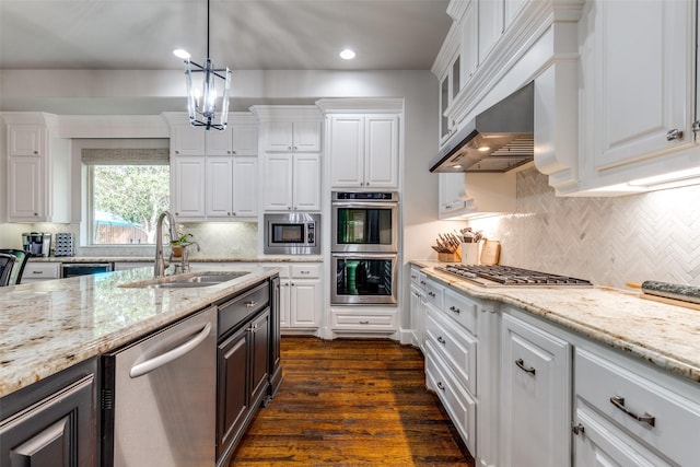 kitchen with a sink, decorative backsplash, white cabinets, and stainless steel appliances