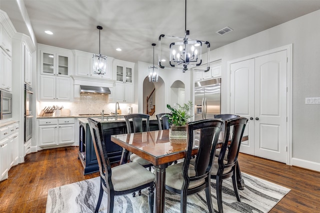 dining room featuring visible vents, dark wood-type flooring, recessed lighting, and a notable chandelier