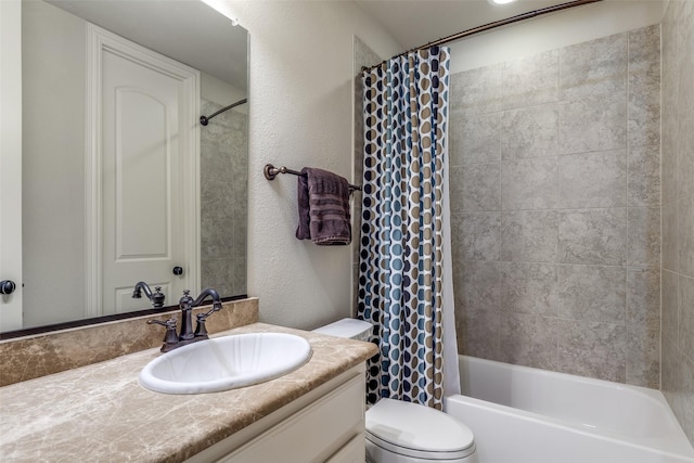 bathroom with toilet, a textured wall, shower / bathtub combination with curtain, and vanity