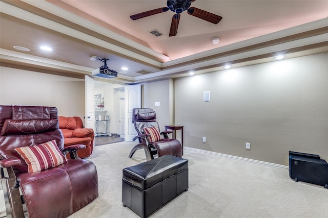 carpeted living room with a raised ceiling, a ceiling fan, recessed lighting, and visible vents