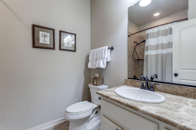 bathroom featuring vanity, toilet, and curtained shower
