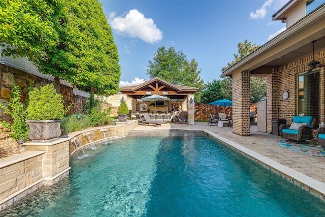 view of pool featuring fence, ceiling fan, a fenced in pool, an outbuilding, and a patio