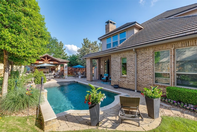 view of pool featuring fence, a fenced in pool, and a patio area