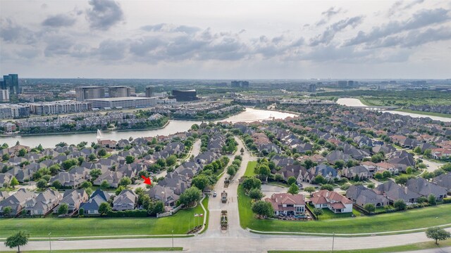 drone / aerial view featuring a residential view and a water view