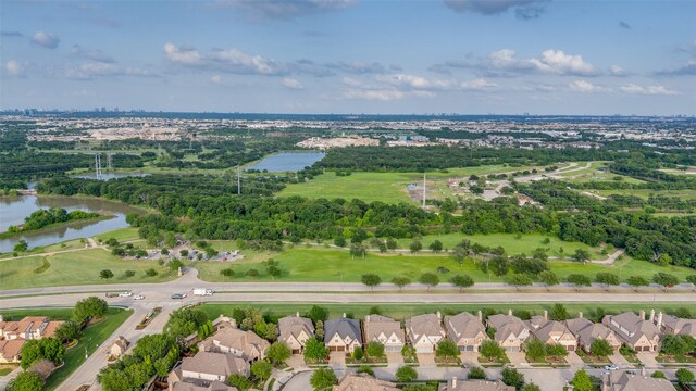 drone / aerial view featuring a water view and a residential view