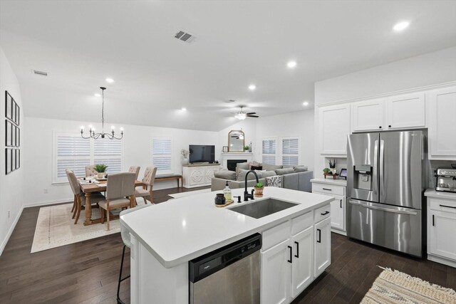 kitchen featuring dark wood-style flooring, visible vents, appliances with stainless steel finishes, a sink, and light countertops
