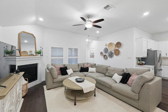 living area with a ceiling fan, visible vents, a fireplace, recessed lighting, and dark wood-type flooring