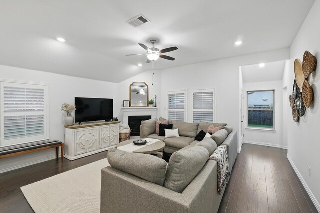 living area with a fireplace, a ceiling fan, baseboards, recessed lighting, and visible vents