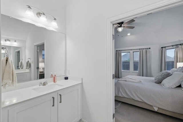 bathroom with connected bathroom, a ceiling fan, a healthy amount of sunlight, and lofted ceiling