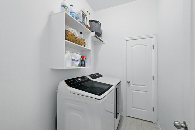 laundry area with separate washer and dryer, laundry area, and light tile patterned flooring