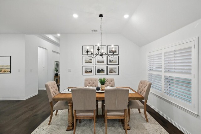 dining space with dark wood-type flooring, baseboards, a chandelier, and visible vents