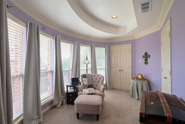 sitting room featuring crown molding, light colored carpet, and visible vents