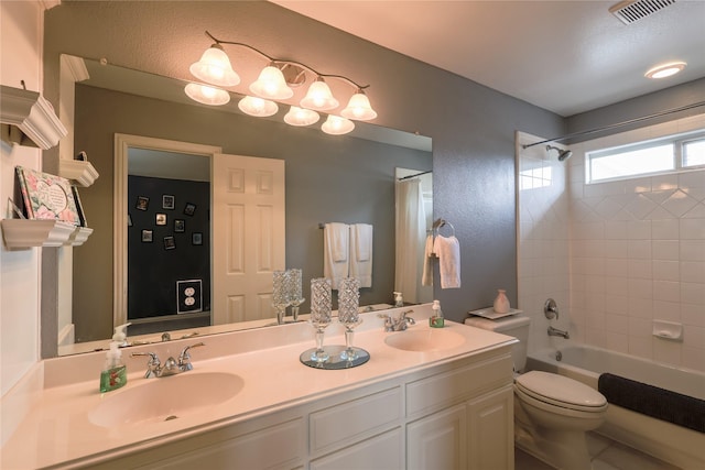 bathroom featuring double vanity, visible vents, tub / shower combination, and a sink