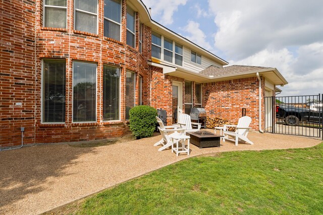 8201 Mckenzie Ct, Frisco, TX 75036 - back of property with brick siding, an outdoor fire pit, a patio, and roof with shingles