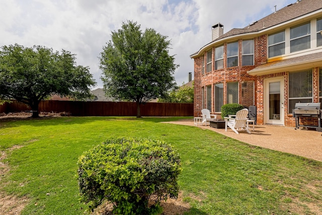 view of yard featuring a patio, a fire pit, and fence private yard