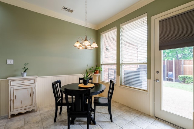 8201 Mckenzie Ct, Frisco, TX 75036 - dining room with a chandelier, crown molding, wainscoting, and light tile patterned floors