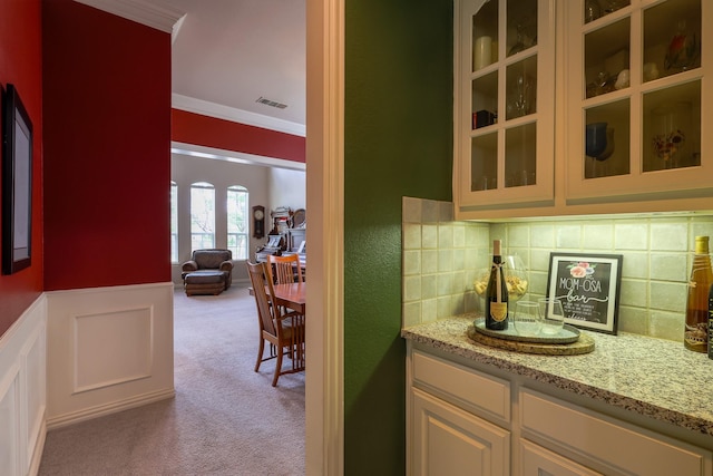 bar with visible vents, ornamental molding, carpet floors, and backsplash