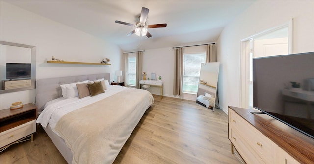 bedroom featuring light wood finished floors, ceiling fan, and lofted ceiling