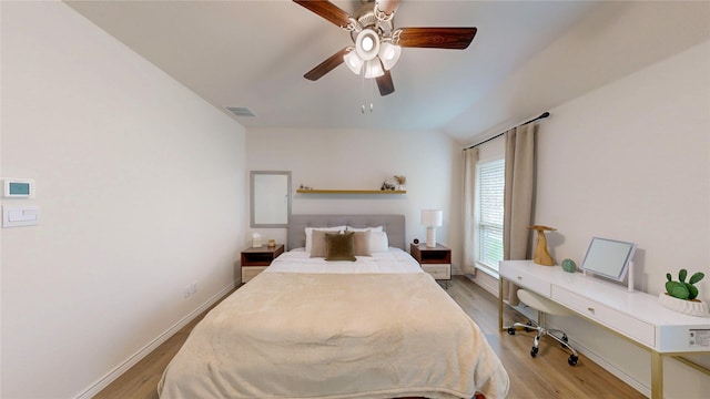 bedroom featuring baseboards, ceiling fan, light wood-style flooring, and visible vents