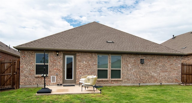 back of house featuring brick siding, fence, a patio area, and roof with shingles