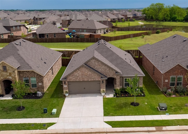 birds eye view of property featuring a water view and a residential view