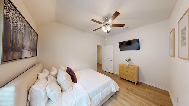 bedroom with a ceiling fan, baseboards, visible vents, and light wood-type flooring