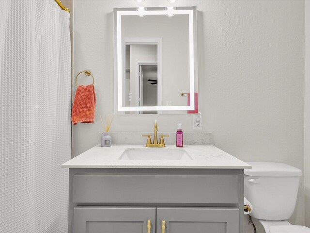 full bathroom with vanity and toilet