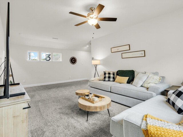 living room featuring baseboards, carpet, and a ceiling fan